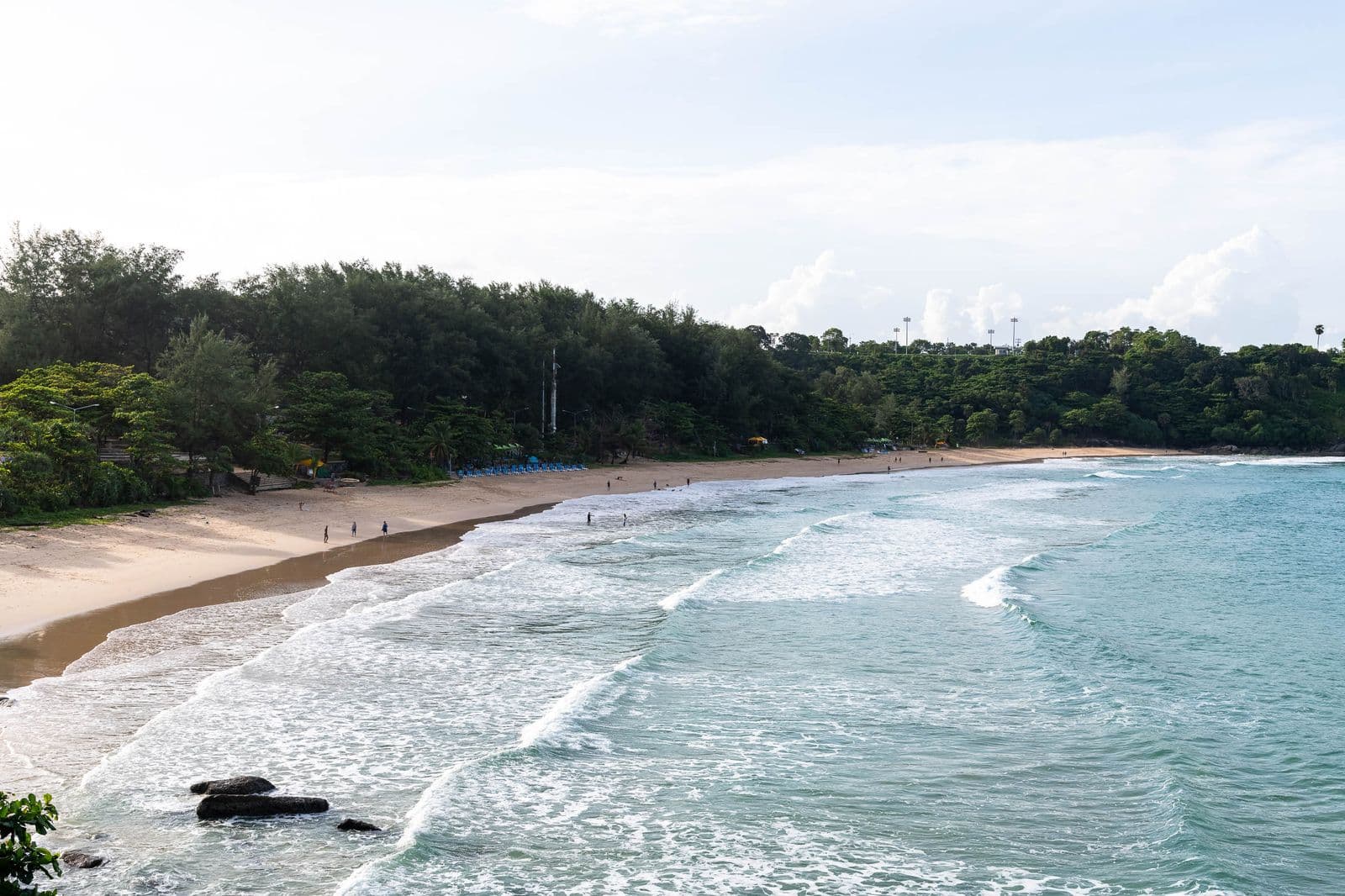 Surf running onto the long curve of Karon beach